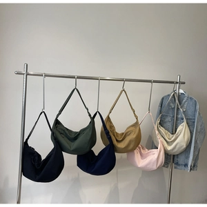 Selection of crescent canvas crossbody bags in six different colors for daily use