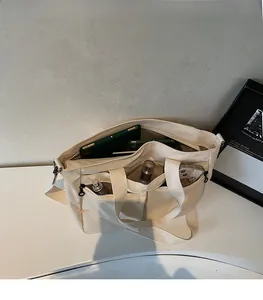 Top view of spacious cream canvas tote interior with pockets for tablets and cosmetics