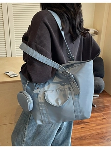 Modern light blue tote bag with adjustable wide shoulder strap and round coin purse