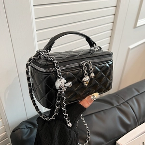 Elegant black quilted handbag with silver chain strap and decorative heart pendant