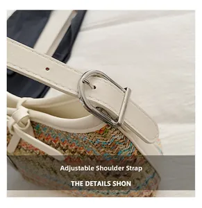 Detail of adjustable white leather strap with silver buckle on colorful woven handbag