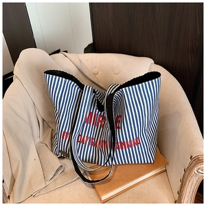 Detail of blue and white striped canvas tote bag with red Mirror letter print