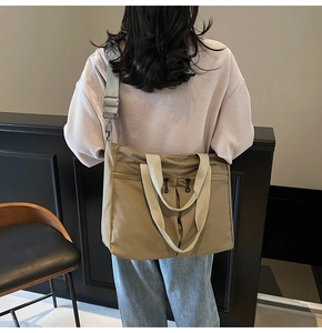 Rear view of khaki nylon tote bag showing its large capacity and stylish crossbody strap