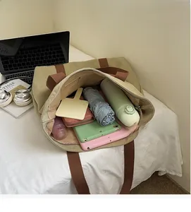 Detailed interior of a large canvas tote bag showing spacious storage for laptop and books