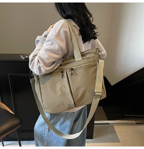 Close-up of khaki nylon tote bag showing durable texture and multi-pocket details