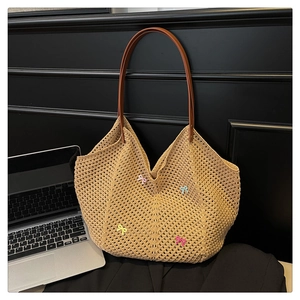 Detailed macro view of woven tote bag featuring colorful bows and leather handles