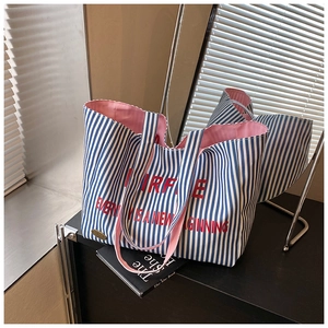 Detail of blue and white striped canvas tote bag with pink lining and interior capacity