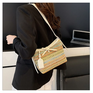 Detail of colorful woven straw texture with white leather trim and a decorative bow