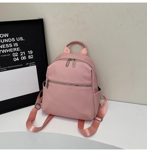 Detail of pink mini backpack with herringbone texture fabric and glossy nylon straps