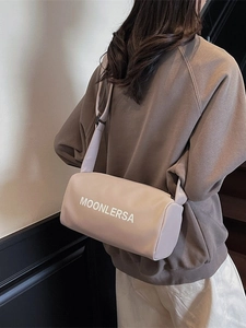 Pink canvas pillow crossbody bag with wide shoulder strap and Moonlersa print
