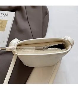 Close-up of woven bucket bag featuring smooth silver metal zipper and interior space