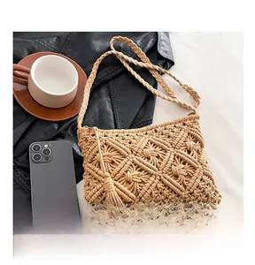 Detail showing hand-woven macramé texture and long tassel of the khaki cotton shoulder bag
