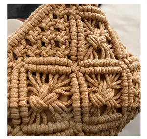 Macro detail of hand-knitted cotton thread diamond patterns on a bohemian bag
