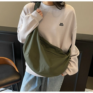 Olive green nylon dumpling bag close-up showing large capacity and smooth zipper design