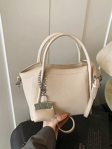 Chic beige lychee grain tote bag with adjustable shoulder strap and mini charm