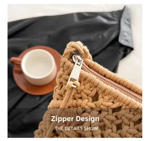 Detailed close-up of the smooth metal zipper on the khaki crochet shoulder bag