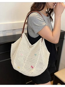 White woven crochet tote bag with colorful butterfly bows and brown leather straps