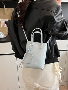 Mini light blue bucket bag with leather handles and long shoulder strap for women
