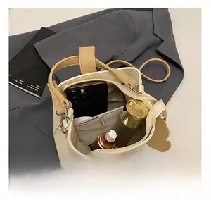 Top view of cream bucket bag interior showing spacious storage and inner zipper pocket