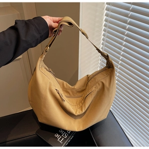 Macro shot of khaki hobo bag details showing zipper closure and adjustable shoulder strap