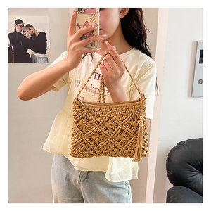 Detail of hand-woven cotton crochet bag featuring geometric patterns and side fringe