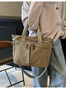 Large khaki tote bag with dual front zippers and adjustable strap for daily travel