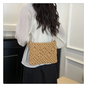 Detail of khaki crochet knit shoulder bag showing handmade geometric hollow patterns