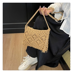 Detailed knit pattern on beige crochet shoulder bag with long bohemian tassels