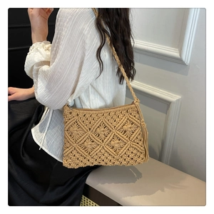 Detailed view of beige crochet crossbody bag with diamond knit pattern and fringe tassel