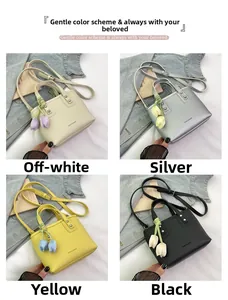 Detail showing minimalist bucket bags in beige, silver, yellow, and black with tulip charms
