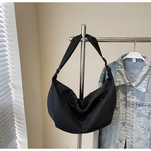 Close-up of black nylon hobo bag with adjustable wide strap for daily commuting