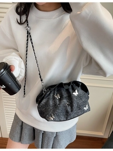Chic dark grey denim crossbody bag with silver butterfly charms and chain strap