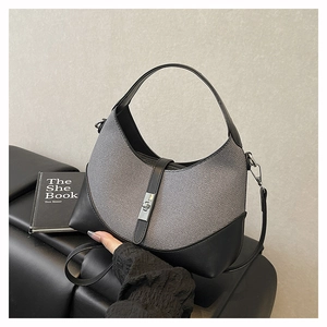 Close-up of the grey woven texture and black leather stitching with silver metal buckle