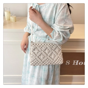 Detail shot of cream white crochet crossbody bag showing woven diamond textures