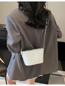 Ice blue woven leather underarm bag for women showing crossbody style on a model