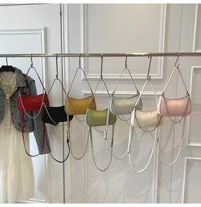 Detail of multi-color crescent crossbody bags with adjustable straps and metal chains