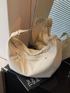 Minimalist beige crescent moon hobo bag with adjustable wide strap for daily travel