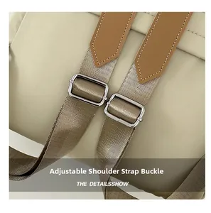 Detail of adjustable nylon shoulder straps with silver metal buckles on a travel backpack