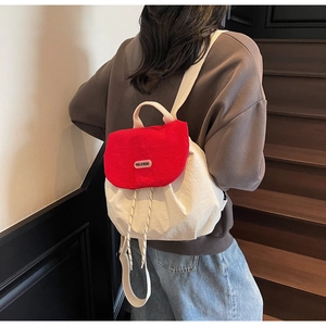 Detail of red and white drawstring backpack with YOU JI BEAR leather logo patch