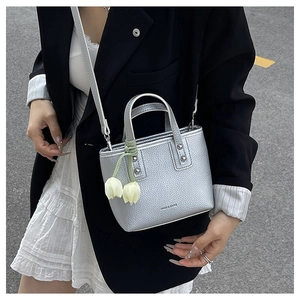 Silver mini bucket bag in lychee leather featuring a tulip charm and metallic finish