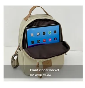 Front zipper pocket of nylon backpack storing a tablet to show large capacity