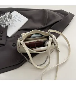 Top view of cream white PU shoulder bag showing spacious interior with zipper pocket