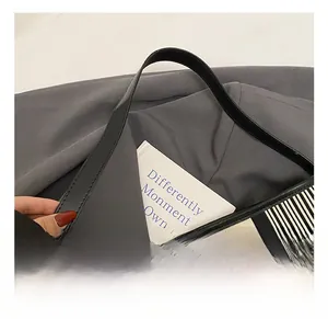 Detail of black and white striped canvas tote with premium leather handle and grey lining