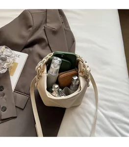 Spacious interior of beige lychee leather bucket bag with phone and cosmetics
