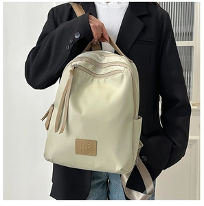 Detail of multi-pocket off-white waterproof nylon backpack with a stylish K letter logo