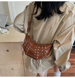 Borsa a mezzaluna vintage marrone con rivetti argentati e tracolla annodata vista da dietro
