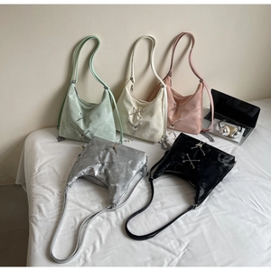 Detail of Y2K style tote bags featuring metallic butterfly charms and fringe accents