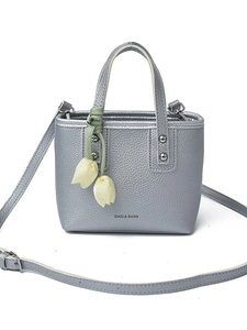 Silver lychee grain mini bucket bag with tulip charm and metallic rivets on white background