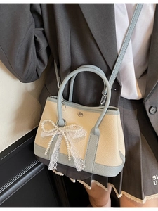 Litchi pattern leather bucket bag in beige and blue with pearl lace bow detail
