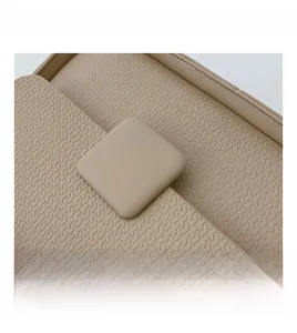 Macro detail of beige leather crossbody bag with stylish wavy embossed texture and square buckle